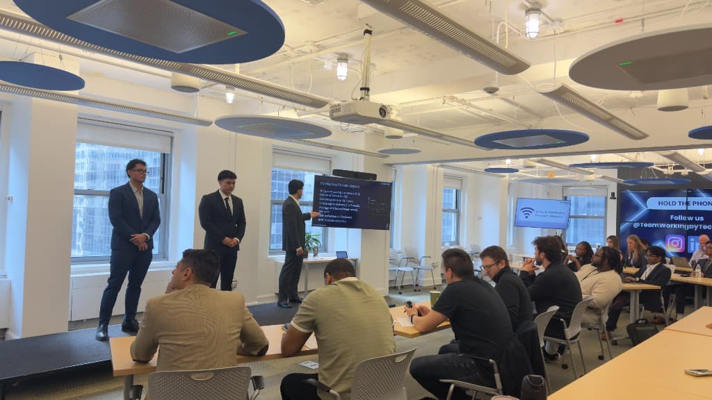 A founder team presenting on stage to a seated audience